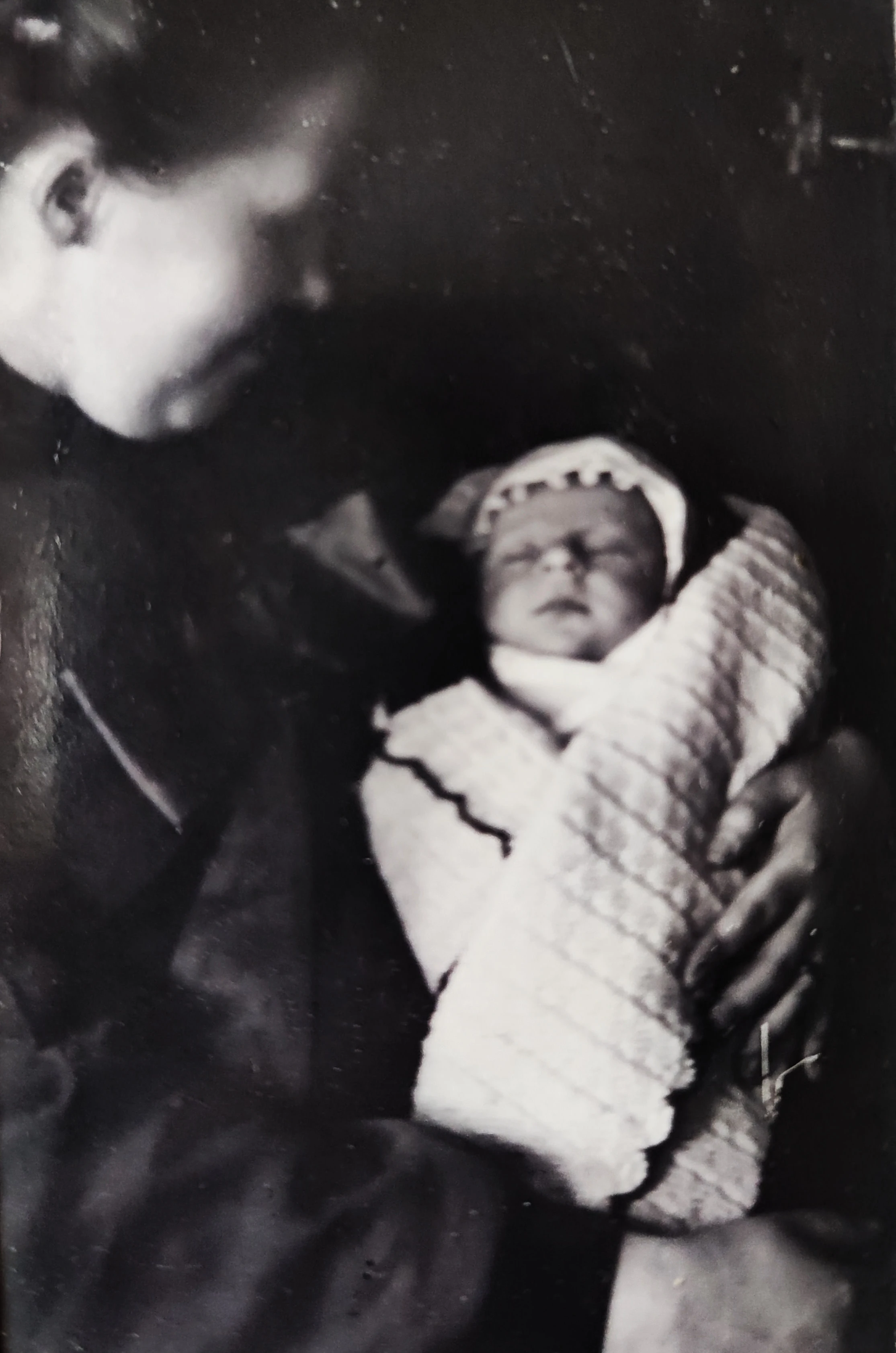 Old phototograph a newborn baby with his mother